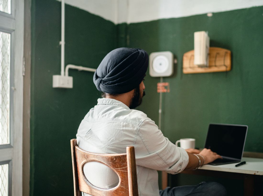 Indian exporter focused on work at a calm wooden desk setup